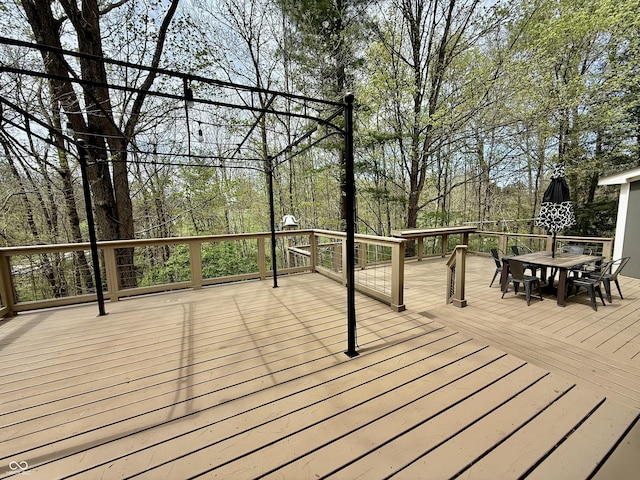 wooden deck featuring outdoor dining area