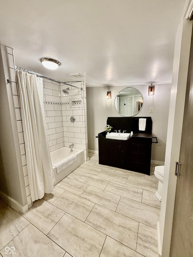 bathroom with toilet, shower / bathtub combination with curtain, vanity, and baseboards