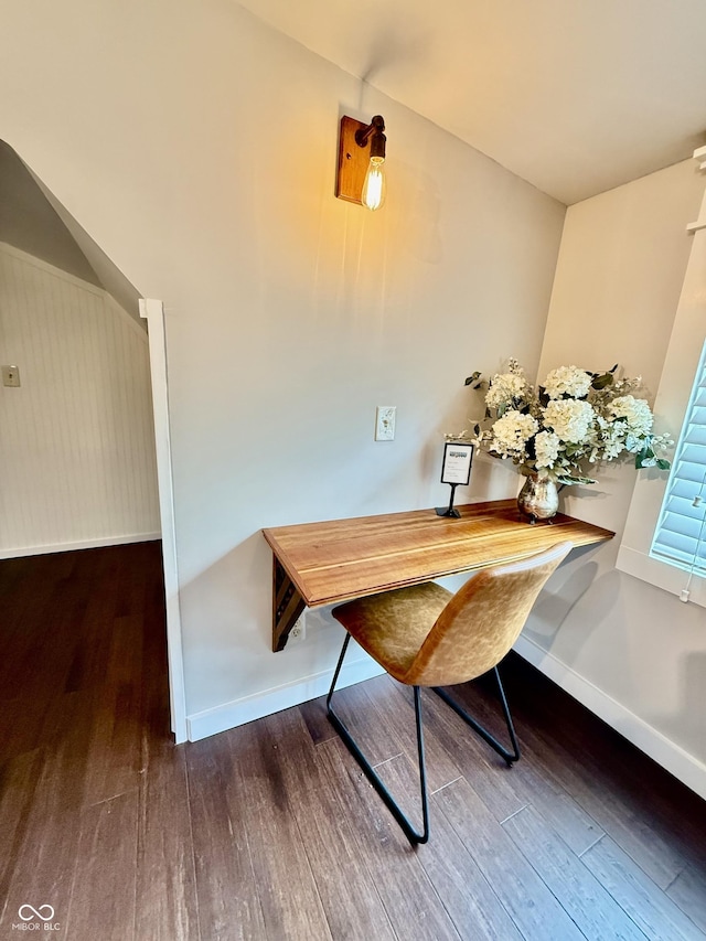 dining area featuring wood finished floors and baseboards