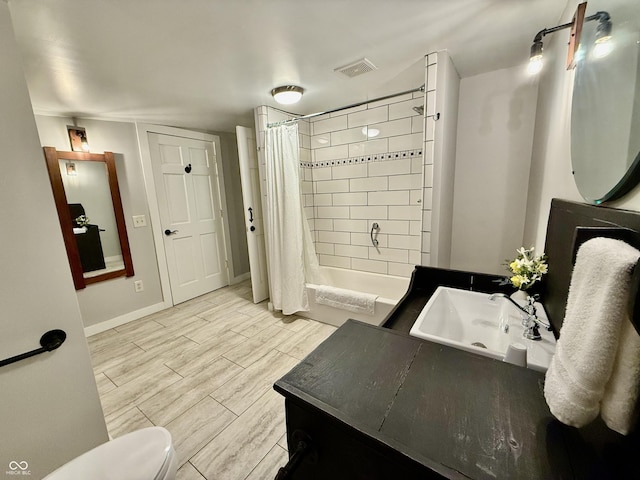 full bath featuring visible vents, baseboards, toilet, wood finished floors, and vanity
