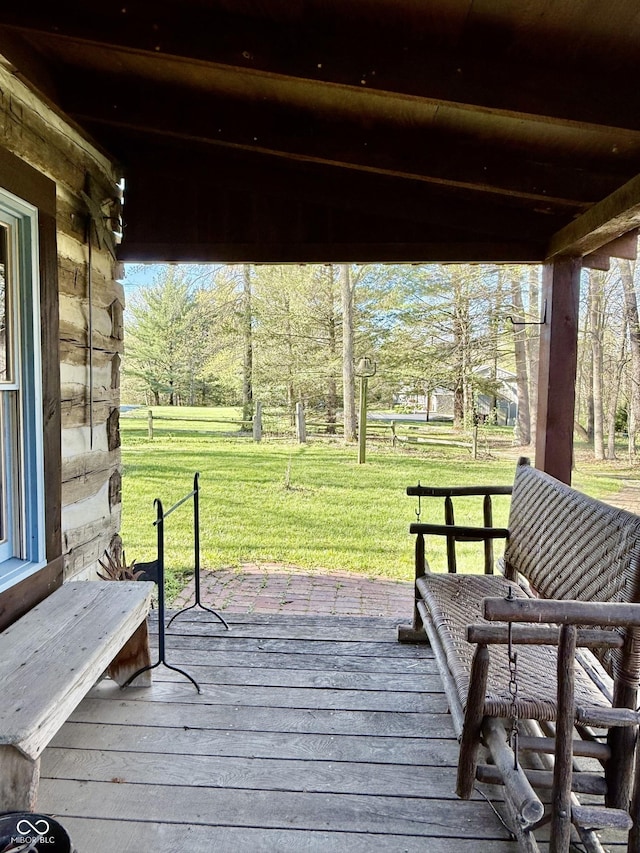 wooden terrace with a lawn