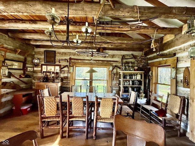 dining room with lofted ceiling with beams and an inviting chandelier