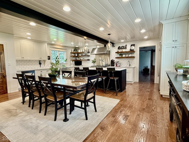 dining area with recessed lighting, light wood finished floors, and wooden ceiling