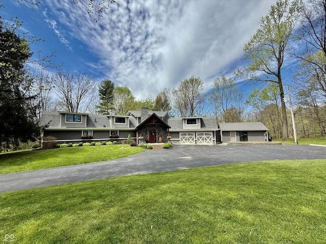 view of front of property with a front yard, driveway, an attached garage, and roof with shingles