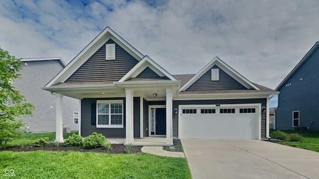 6118 Aspen Meadow Dr, Indianapolis, IN 46237 - view of front facade featuring a porch, a garage, a front lawn, and concrete driveway