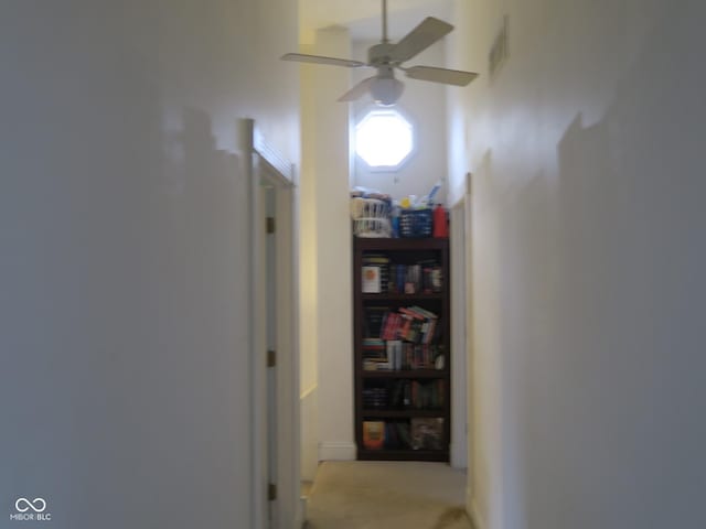 hall with visible vents and carpet