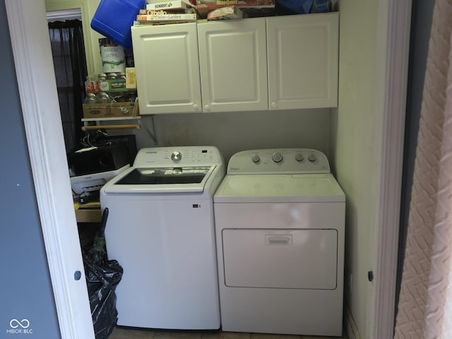 washroom featuring cabinet space and separate washer and dryer