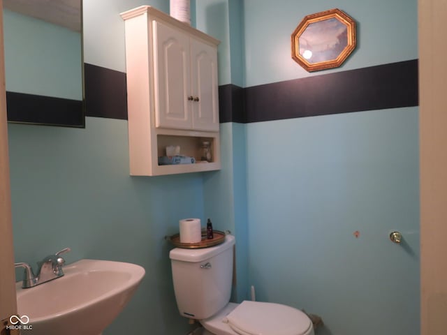 bathroom with toilet and a sink