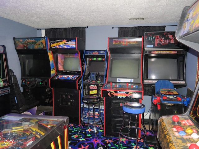 game room with a textured ceiling
