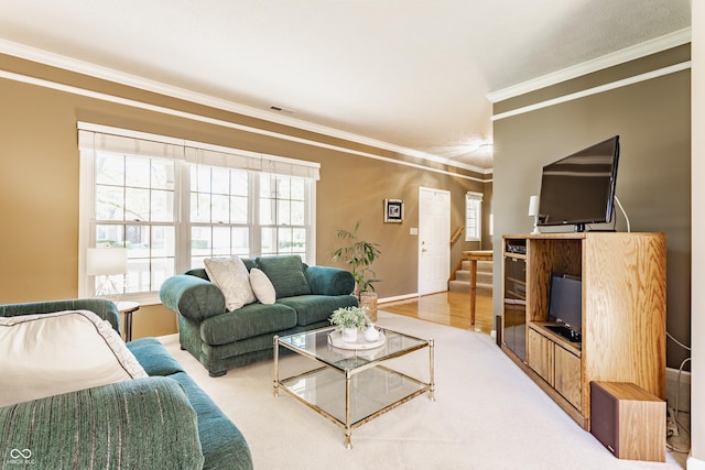 living area with baseboards, visible vents, ornamental molding, and plenty of natural light