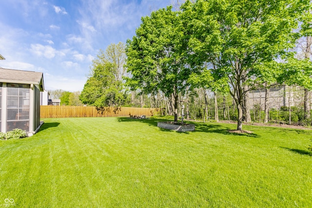 view of yard featuring fence and a garden