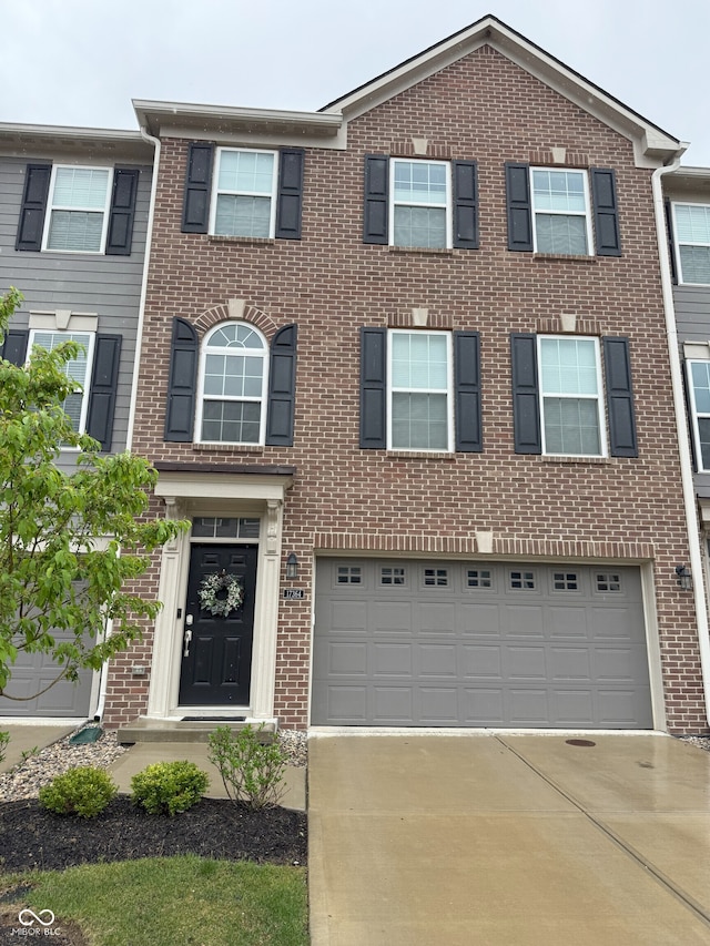 view of front of home featuring brick siding, driveway, and a garage
