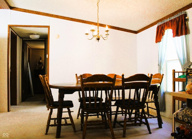 carpeted dining space with ornamental molding, a textured ceiling, and a notable chandelier
