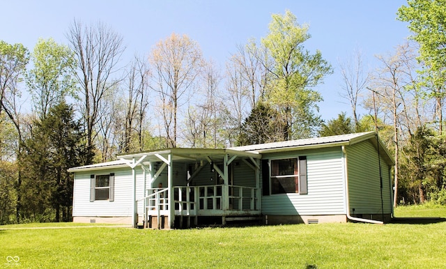 manufactured / mobile home featuring a porch, a front lawn, crawl space, and metal roof