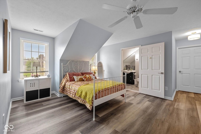 bedroom featuring baseboards, a ceiling fan, wood finished floors, and visible vents