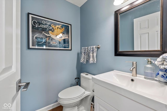 half bathroom with toilet and vanity