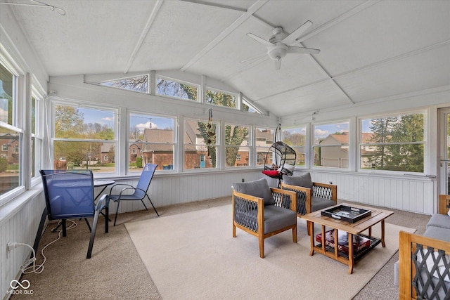 sunroom with carpet and lofted ceiling