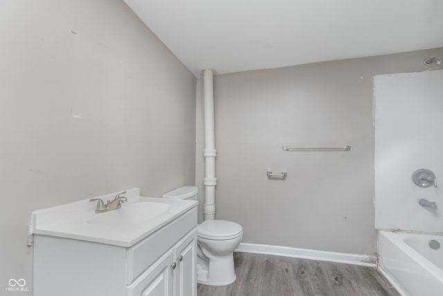 full bathroom with vanity, baseboards, toilet, and wood finished floors