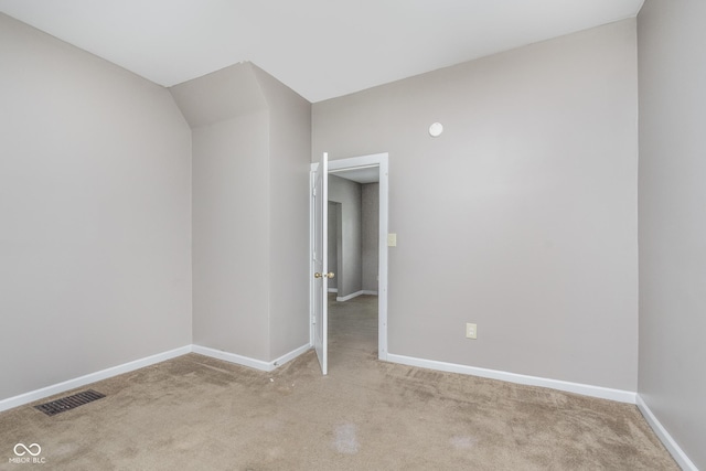 unfurnished room with visible vents, carpet, and baseboards