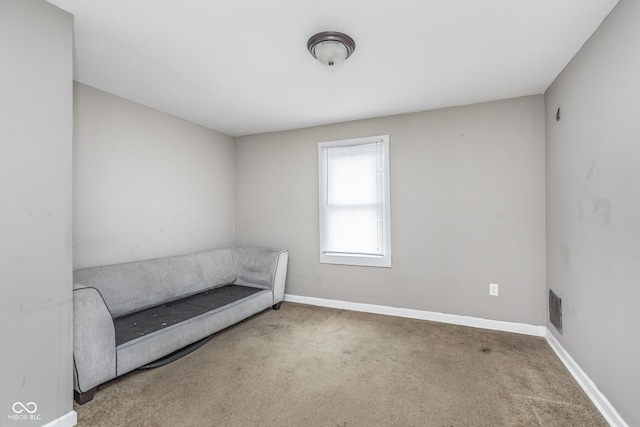 unfurnished room with baseboards and carpet flooring