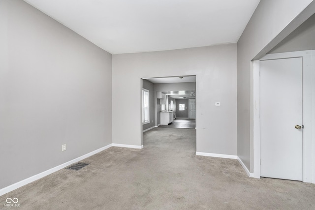 interior space with carpet floors, baseboards, and visible vents