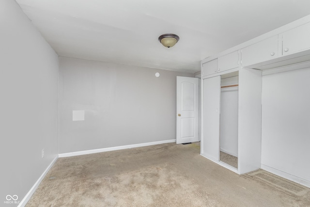 unfurnished bedroom with baseboards and light carpet