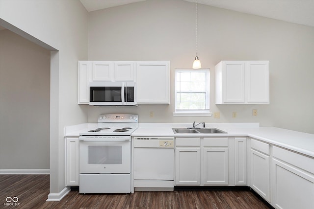 kitchen with vaulted ceiling, a sink, dark wood-style floors, white appliances, and white cabinetry