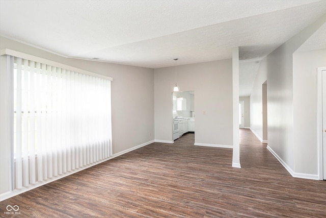 unfurnished living room with baseboards and dark wood-style flooring