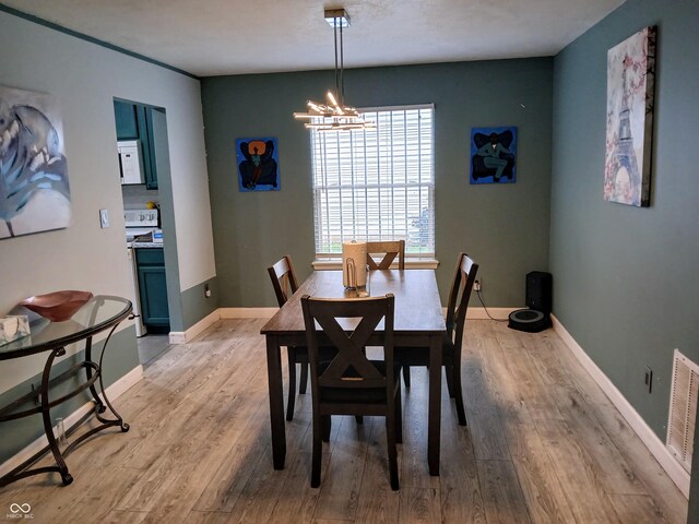 11651 Congressional Ln, Indianapolis, IN 46235 - dining space with baseboards, visible vents, a notable chandelier, and light wood-style floors