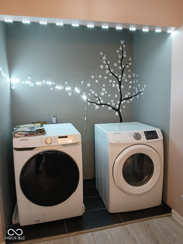 11651 Congressional Ln, Indianapolis, IN 46235 - washroom featuring washing machine and dryer, wood finished floors, and laundry area