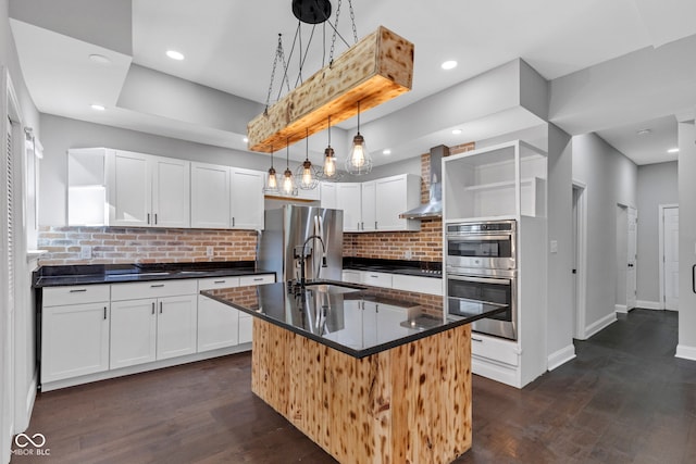 257 N Tacoma Ave, Indianapolis, IN 46201 - kitchen with open shelves, wall chimney range hood, dark countertops, stainless steel appliances, and tasteful backsplash