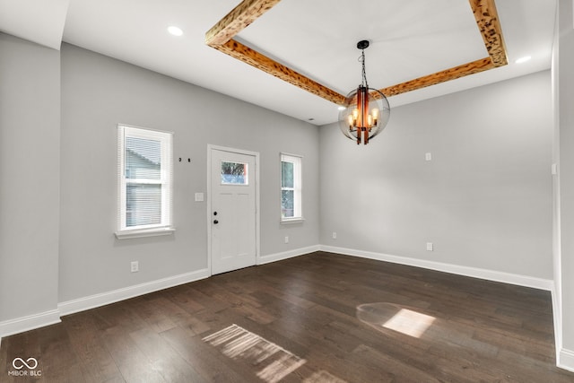 257 N Tacoma Ave, Indianapolis, IN 46201 - foyer with an inviting chandelier, dark wood finished floors, baseboards, and a raised ceiling