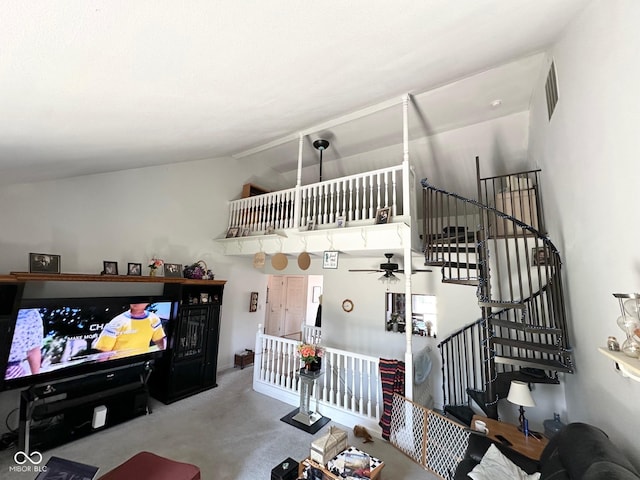 living area with carpet, ceiling fan, lofted ceiling, and visible vents