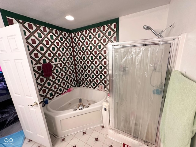 bathroom featuring a tub with jets, a stall shower, and tile patterned floors