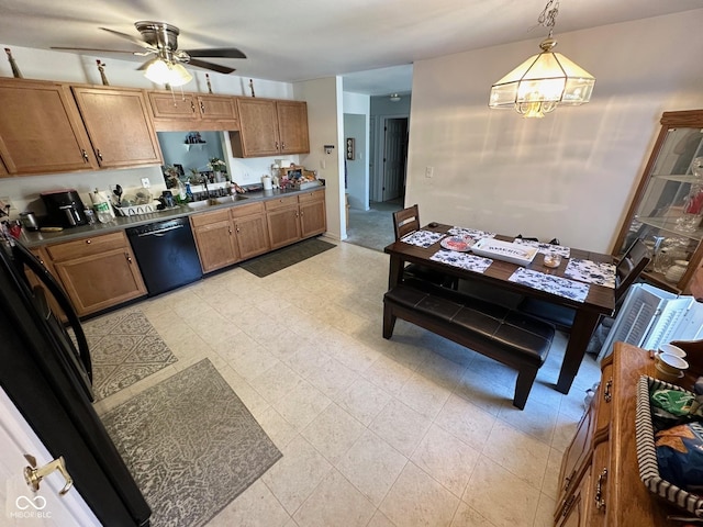 kitchen with black dishwasher, brown cabinetry, dark countertops, hanging light fixtures, and ceiling fan with notable chandelier