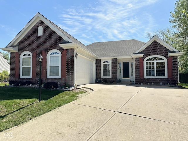 ranch-style home with driveway, an attached garage, a front yard, and brick siding