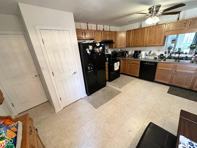 kitchen with black appliances, ceiling fan, brown cabinets, and a sink