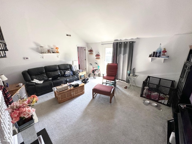 living room with visible vents, carpet flooring, and vaulted ceiling