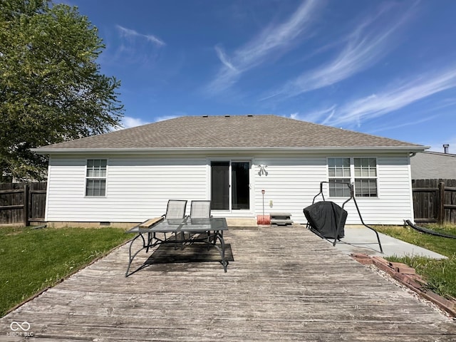 back of property with fence, outdoor dining space, a lawn, and a wooden deck