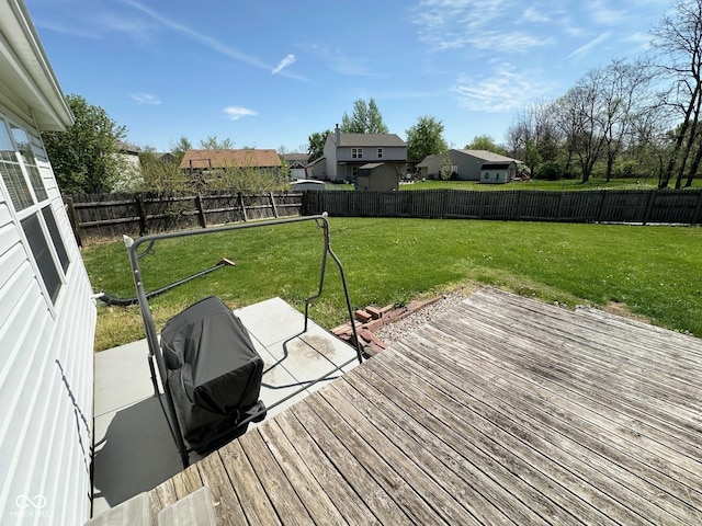 wooden terrace with a fenced backyard, area for grilling, and a yard