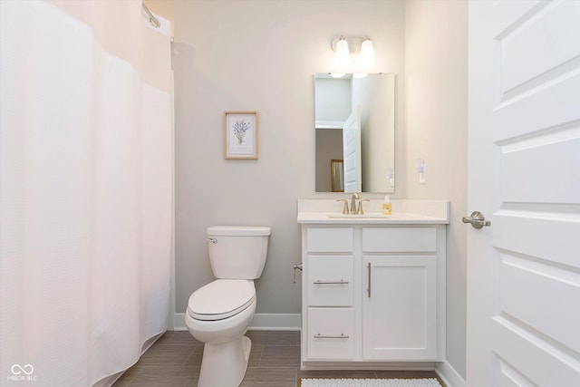 bathroom featuring vanity, baseboards, a shower with curtain, and toilet