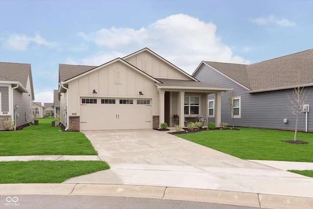 view of front of house featuring roof with shingles, a front lawn, a garage, board and batten siding, and concrete driveway