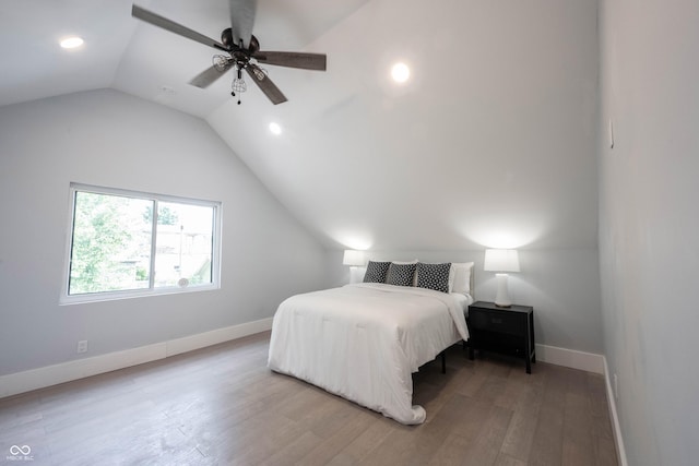 bedroom with light wood-type flooring, recessed lighting, vaulted ceiling, and baseboards