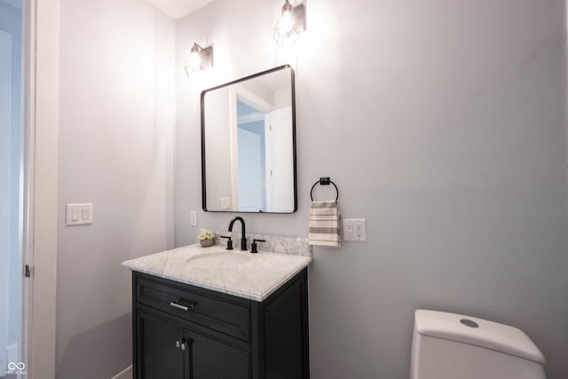 half bathroom featuring toilet and vanity