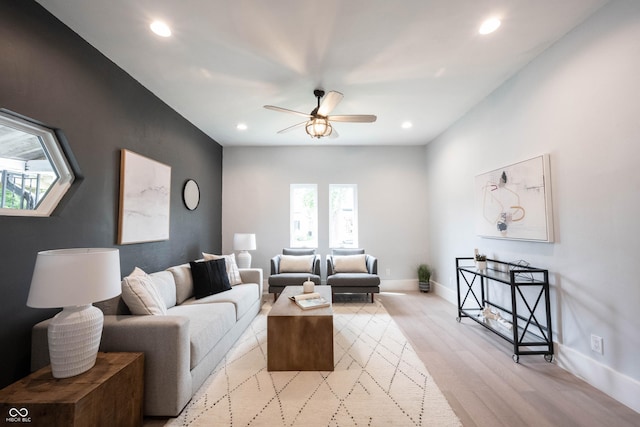 living room featuring ceiling fan, light wood-type flooring, and recessed lighting