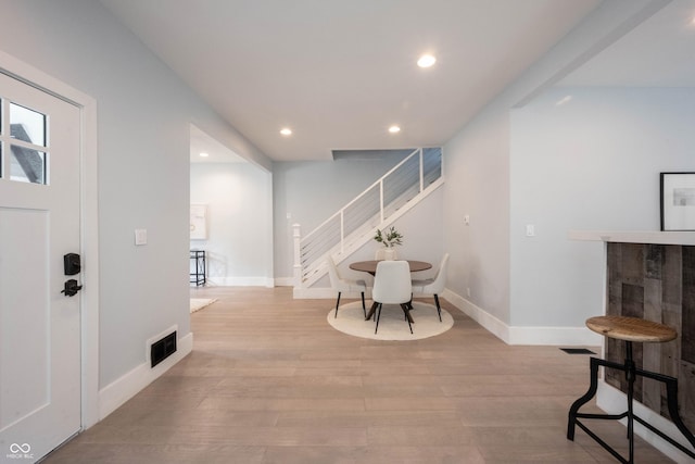 foyer entrance with recessed lighting, wood finished floors, stairway, baseboards, and visible vents