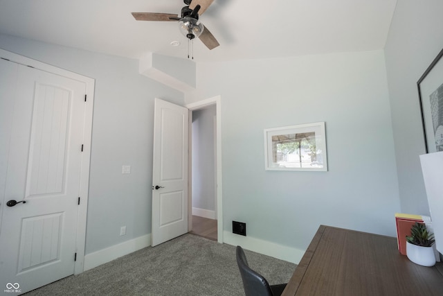carpeted home office with baseboards and ceiling fan