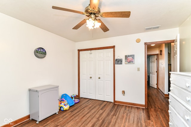 unfurnished bedroom with visible vents, baseboards, wood finished floors, and a closet