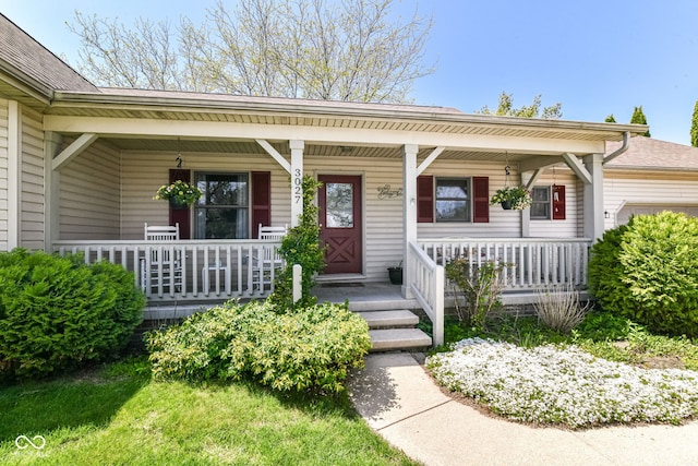 doorway to property featuring a garage and covered porch