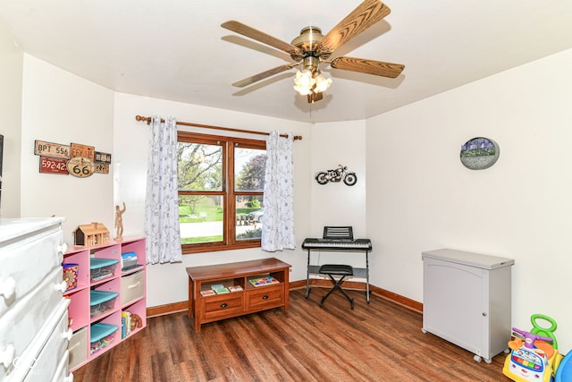 game room with baseboards, ceiling fan, and wood finished floors
